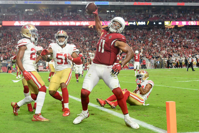 Cardinals wide receiver Larry Fitzgerald spikes the ball after scoring a touchdown against the 49ers during the 2018 season. Fitzgerald has been the face of the franchise for 17 years, but is he the greatest Cardinals player of all time?